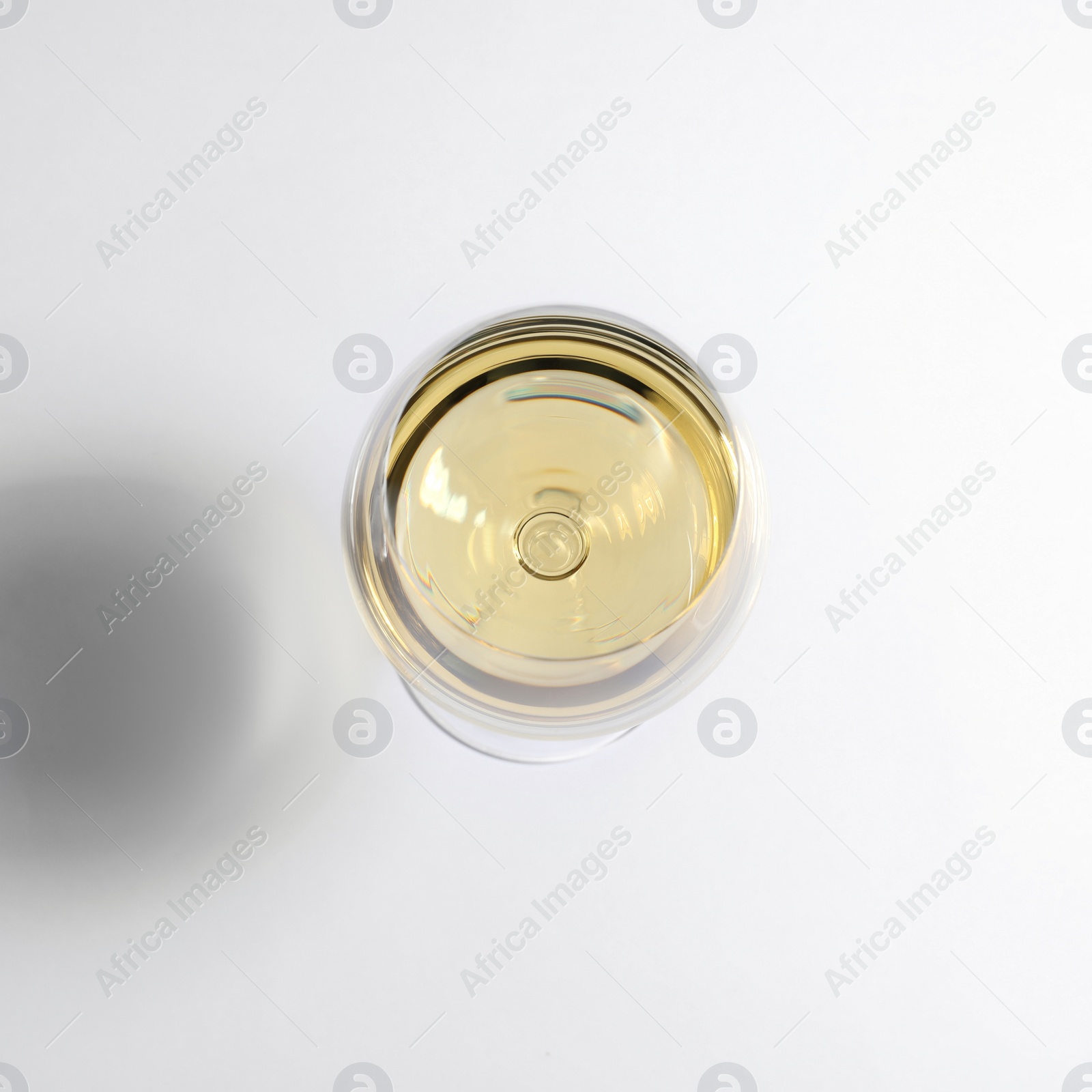 Photo of Glass of wine on white background, top view