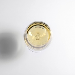 Glass of wine on white background, top view