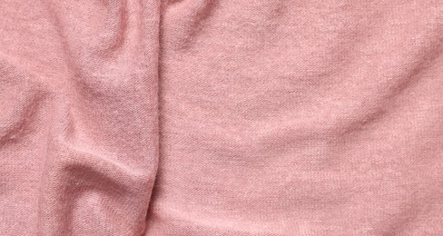 Texture of soft pink crumpled fabric as background, top view