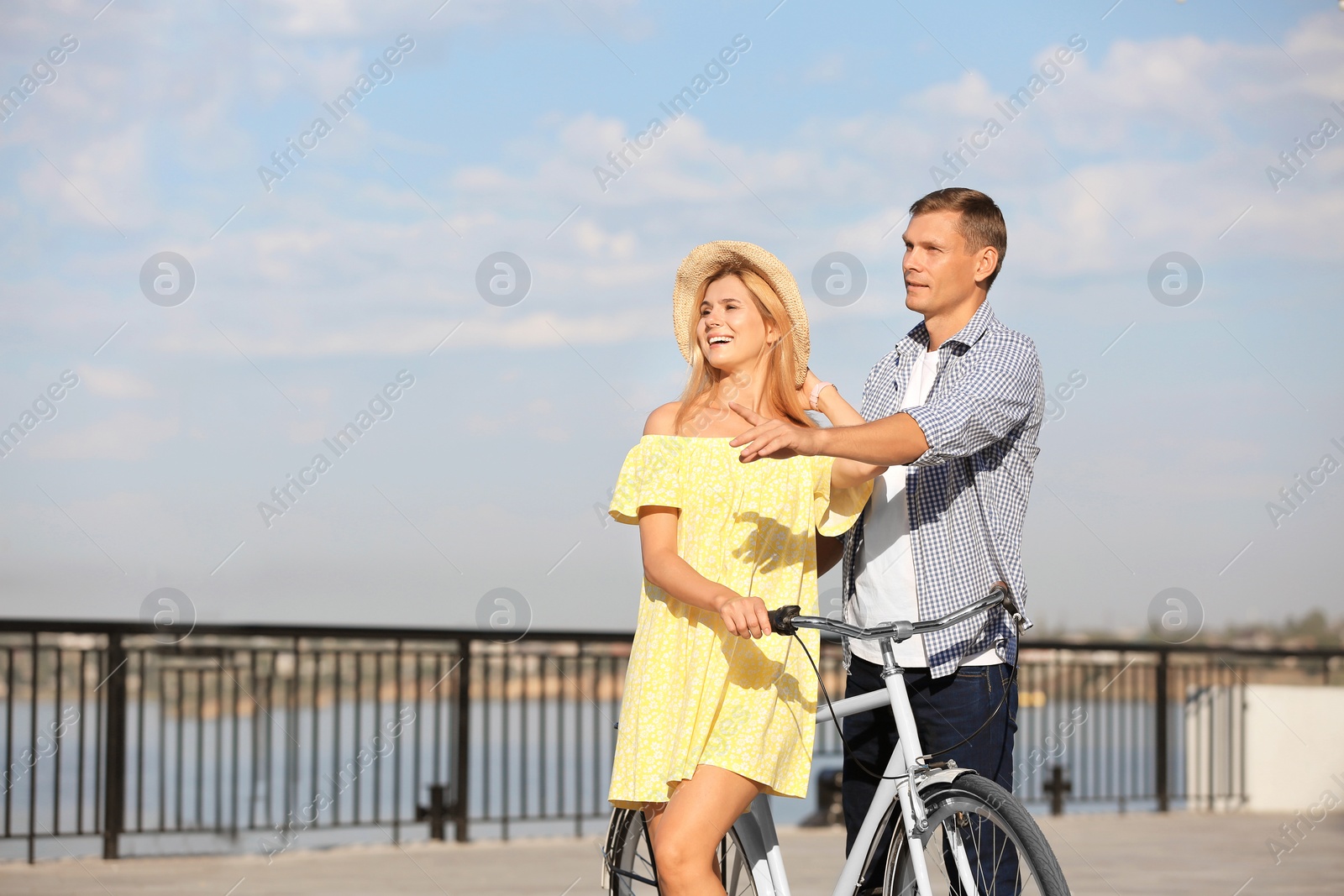 Photo of Happy couple with bicycle outdoors on sunny day