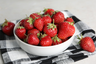 Photo of Delicious ripe strawberries in bowl on table, closeup