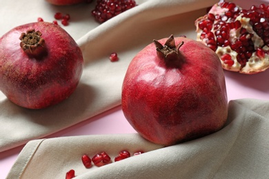 Photo of Delicious red ripe pomegranates on color background