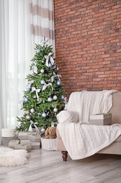 Decorated Christmas tree in stylish living room interior