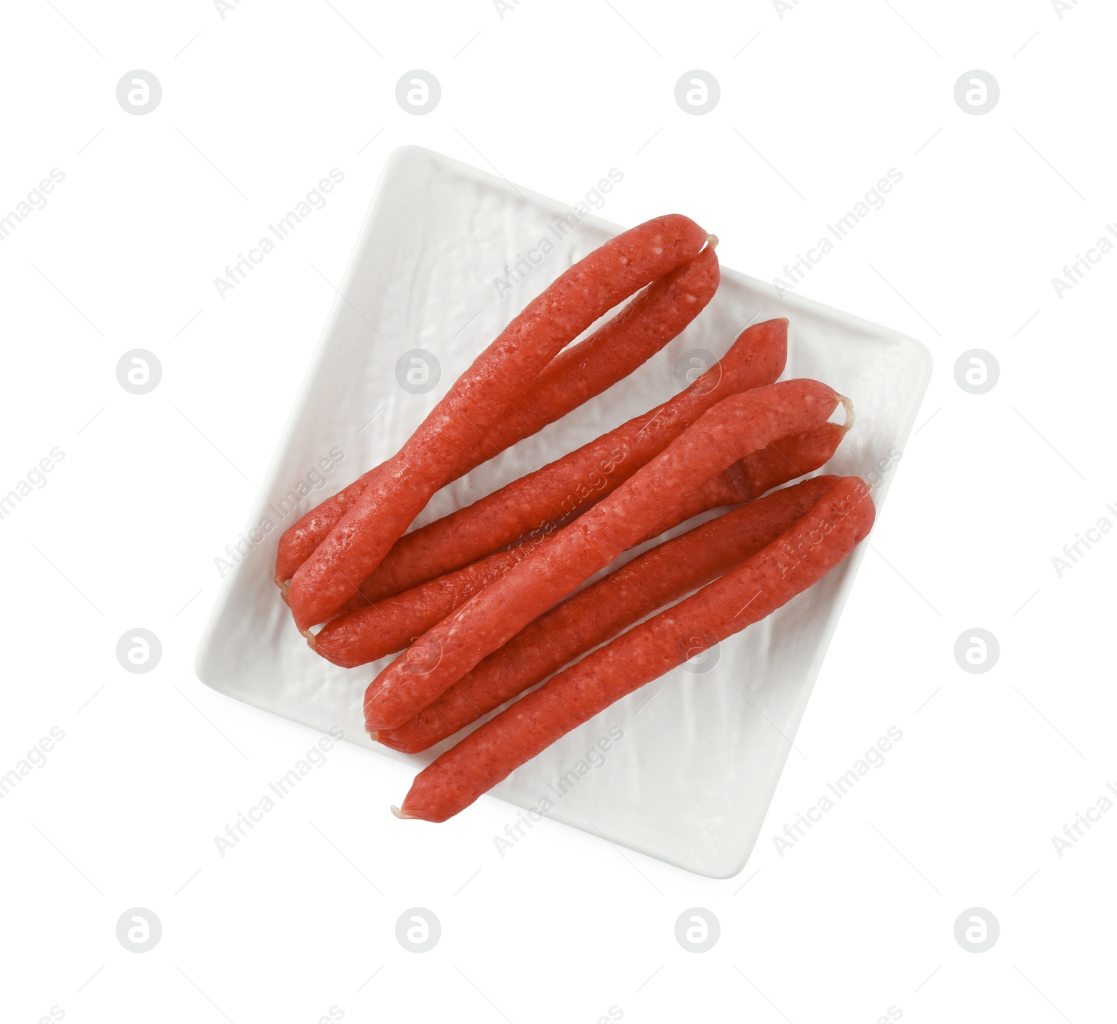 Photo of Thin dry smoked sausages isolated on white, top view