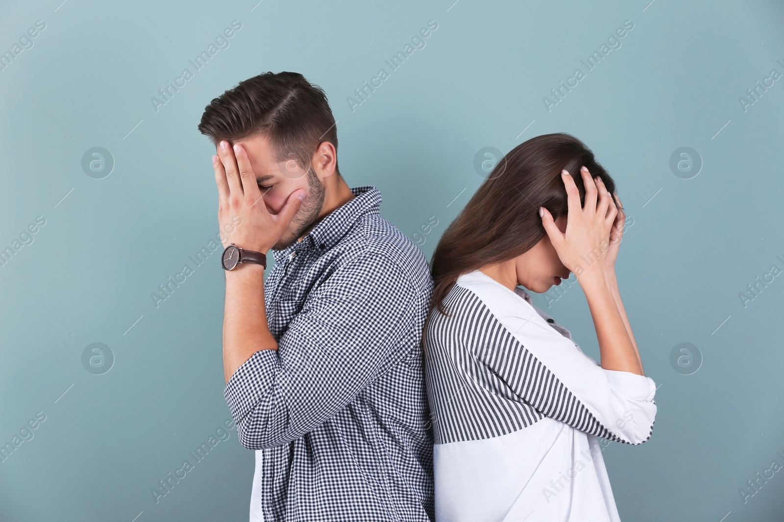 Photo of Upset young couple on color background. Relationship problems