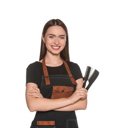 Photo of Portrait of happy hairdresser with brushes on white background