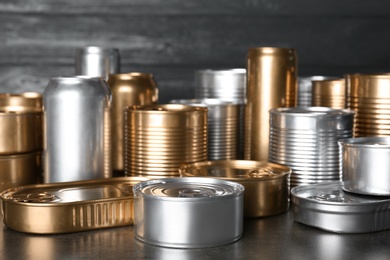 Many tin cans on table. Recycling garbage