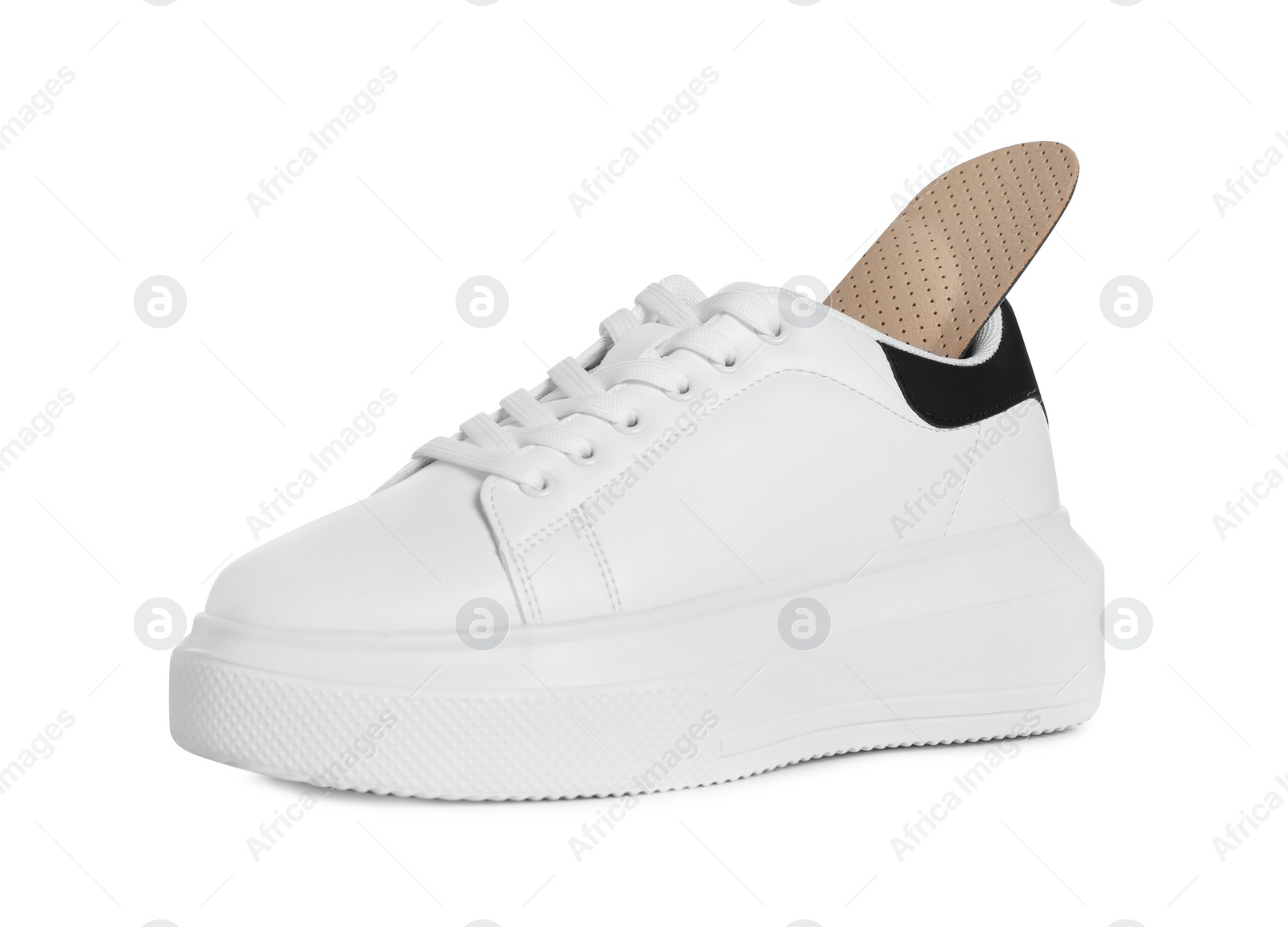 Photo of Orthopedic insole in shoe on white background