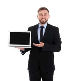 Photo of Happy young businessman holding laptop with empty screen on white background, space for text