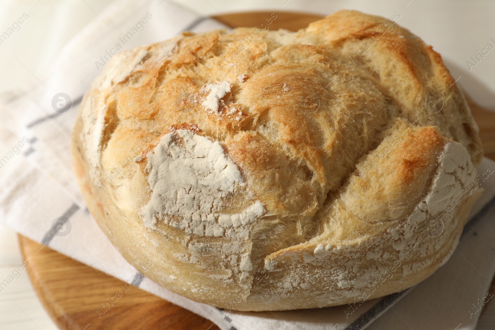 Photo of Freshly baked sourdough bread on white table