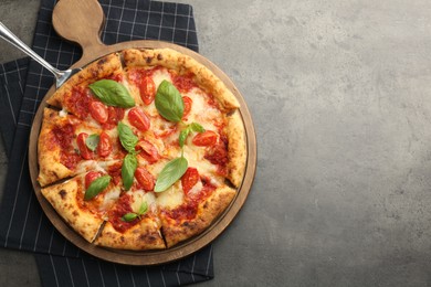 Delicious Margherita pizza on grey table, top view. Space for text