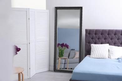 Photo of Elegant bedroom interior with large mirror