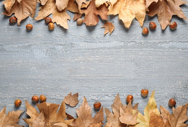 Photo of Frame made of autumn leaves on grey background. Space for text
