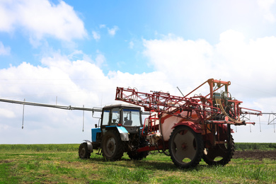 Photo of Modern agricultural equipment in field under cloudy sky