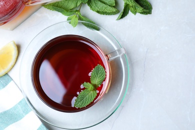 Photo of Fresh tea with mint on light table, flat lay