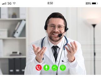 Online medical consultation. Doctor with headset working via video chat application