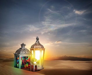 Beautiful Arabic lanterns on sand at sunrise, space for text