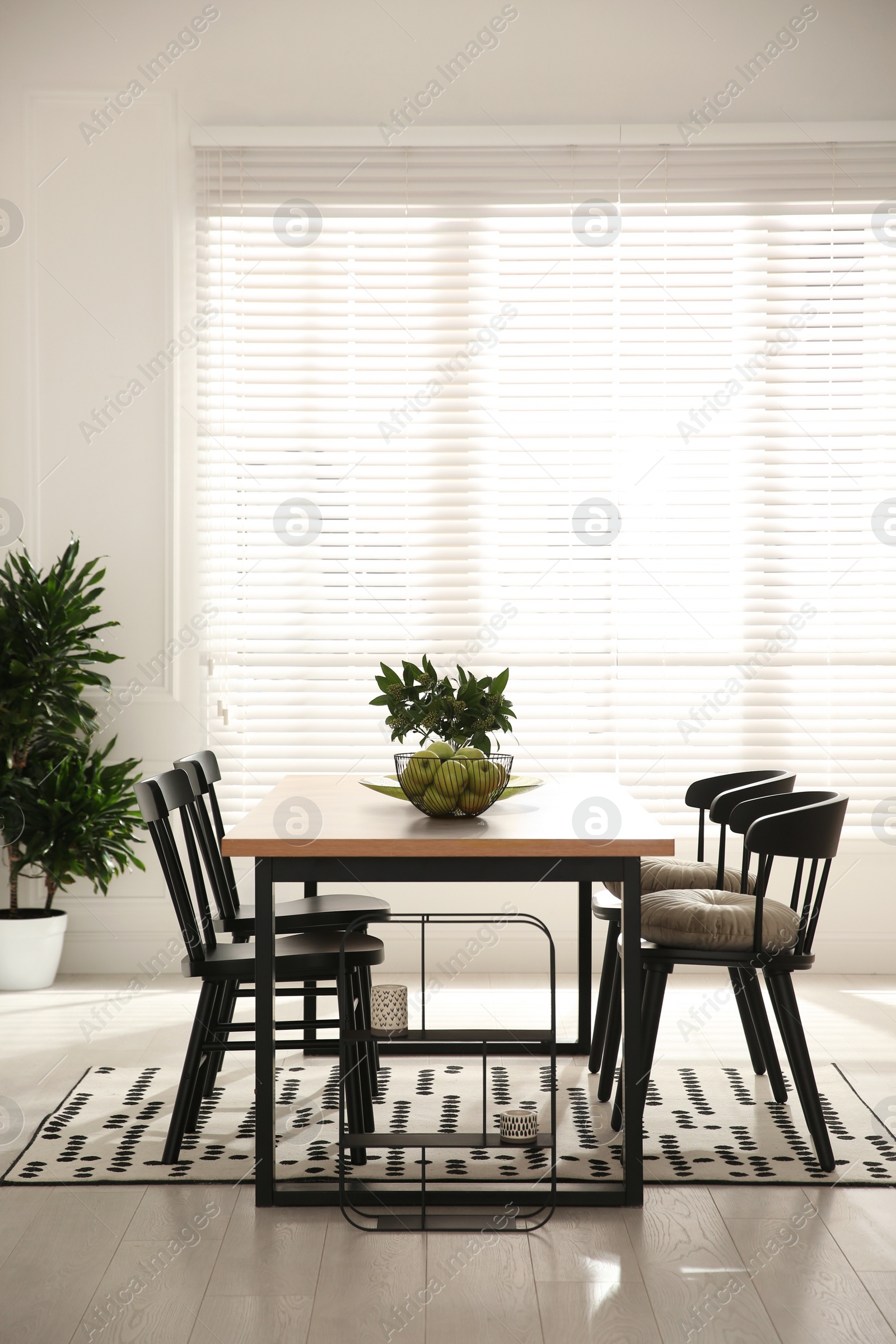 Photo of Stylish wooden dining table and chairs in room. Interior design