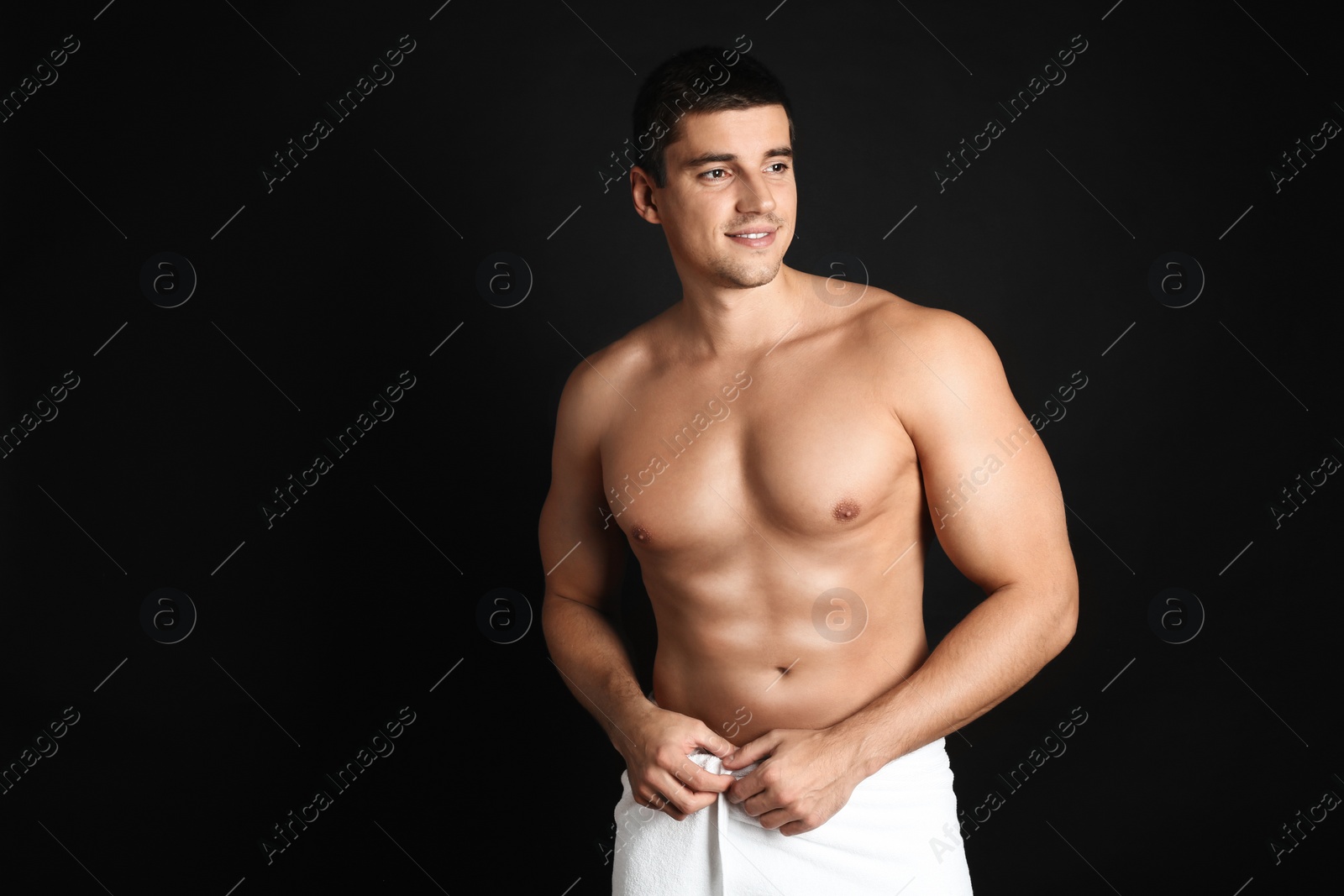 Photo of Man with sexy body on black background. Space for text