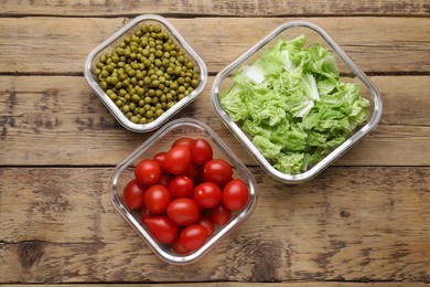 Glass containers with different fresh products on wooden table, flat lay