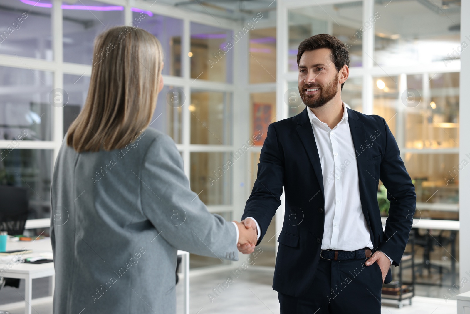 Photo of Lawyer shaking hands with client in office