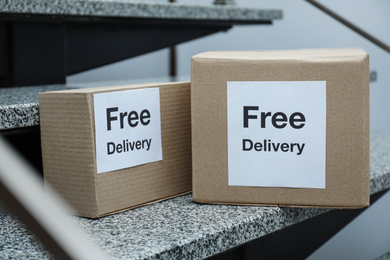Photo of Parcels with stickers Free Delivery on stairs. Courier service