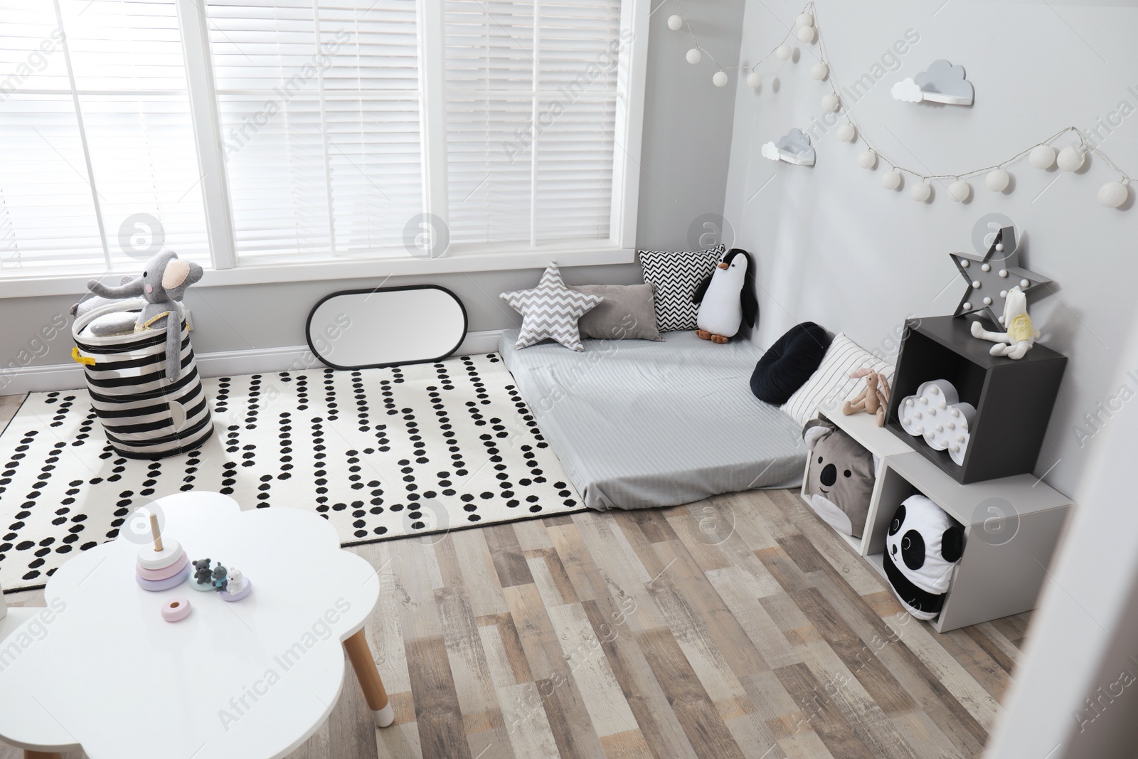 Photo of Montessori bedroom interior with floor bed and toys