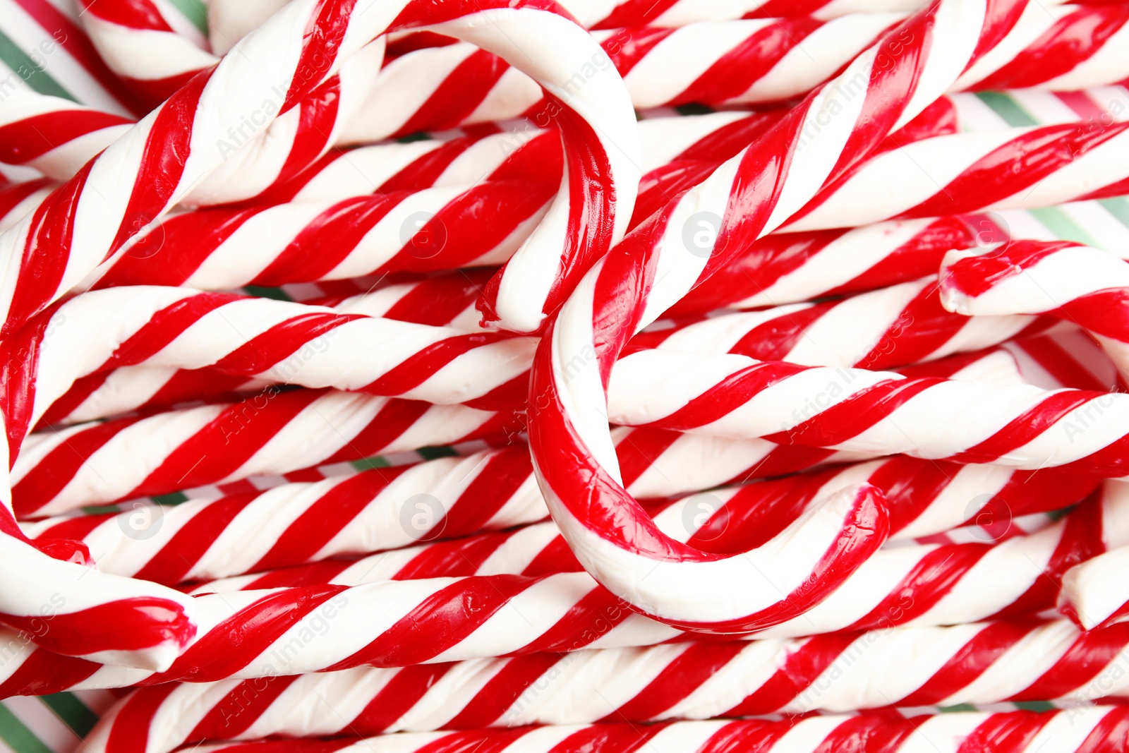 Photo of Many candy canes as background. Festive treat