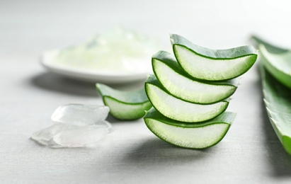 Photo of Fresh sliced aloe vera leaves on light background