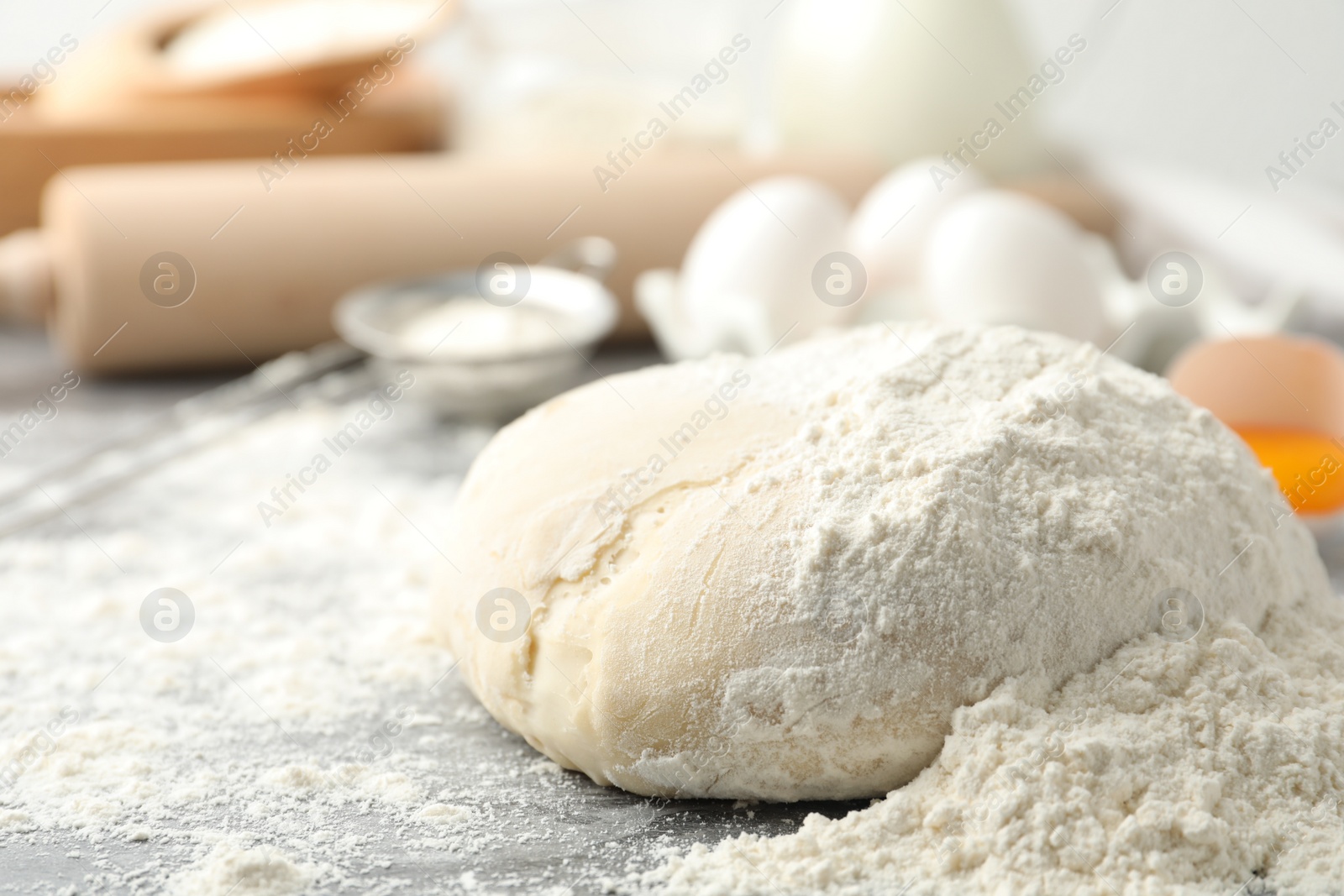 Photo of Wheat dough and products on grey table. Cooking pastries