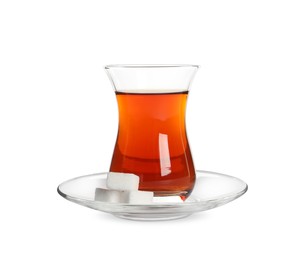 Photo of Glass of traditional Turkish tea with sugar cubes isolated on white