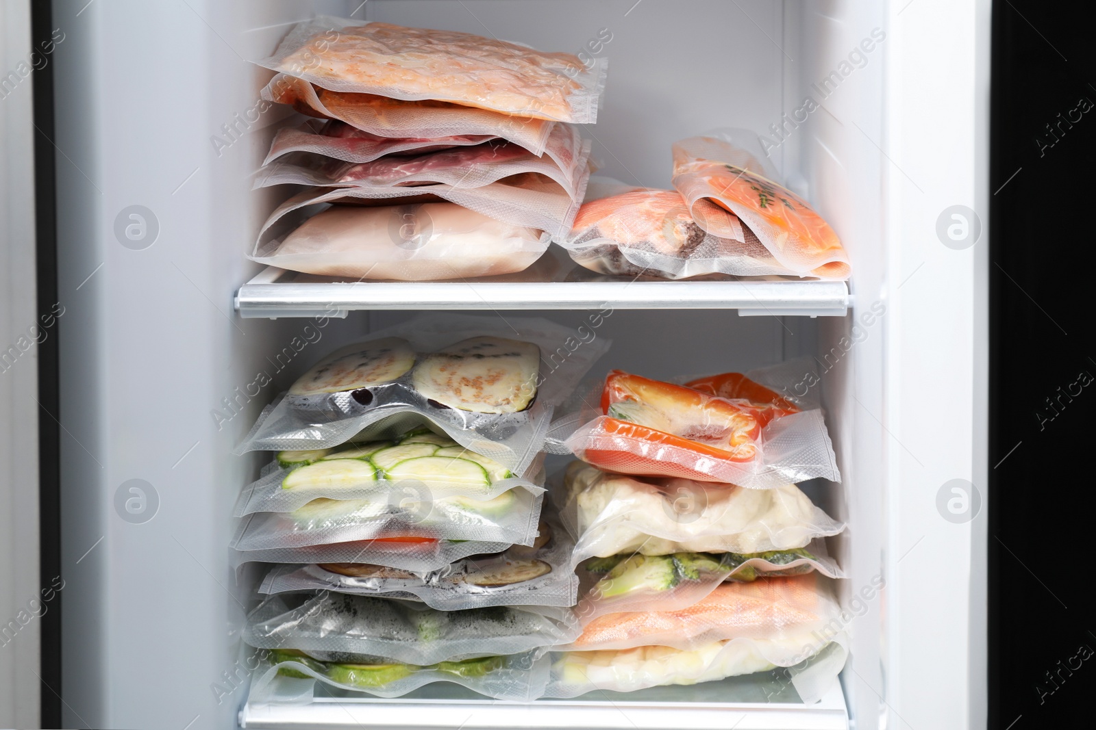 Photo of Vacuum bags with different products in fridge. Food storage