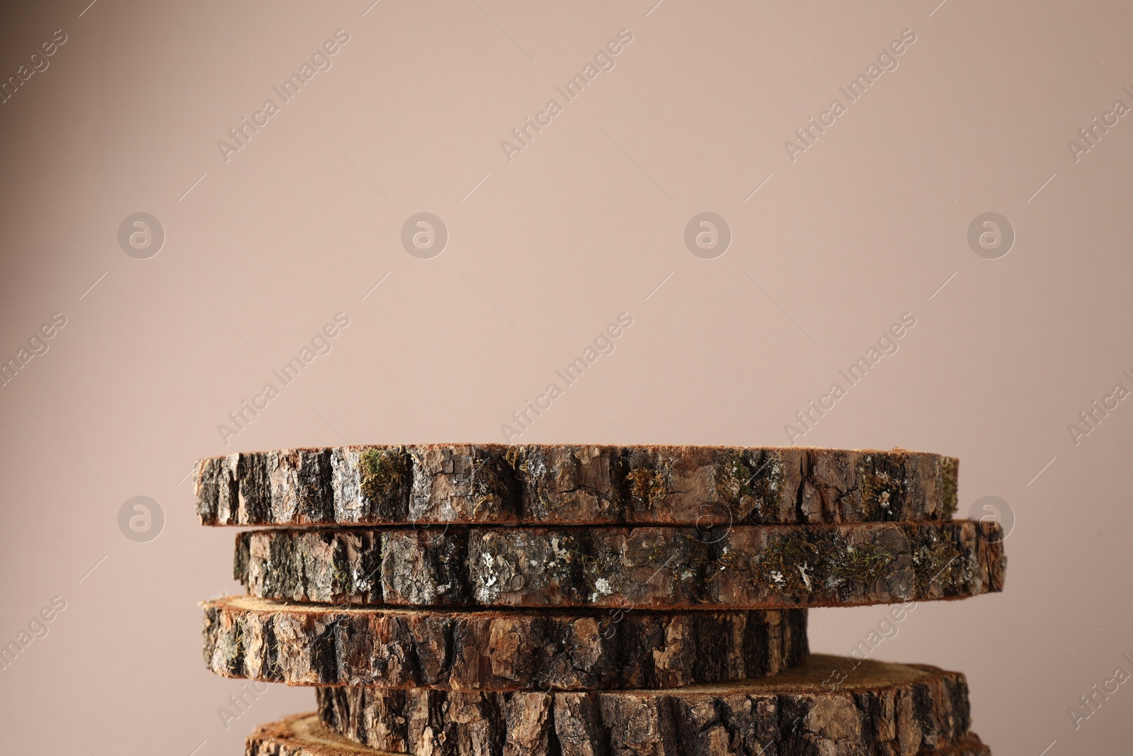 Photo of Presentation for product. Wooden stumps on beige background. Space for text