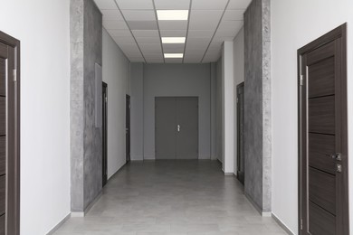 Empty office corridor with wooden doors, Interior design