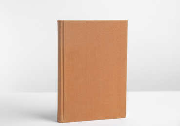 Hardcover book on white background. Space for design