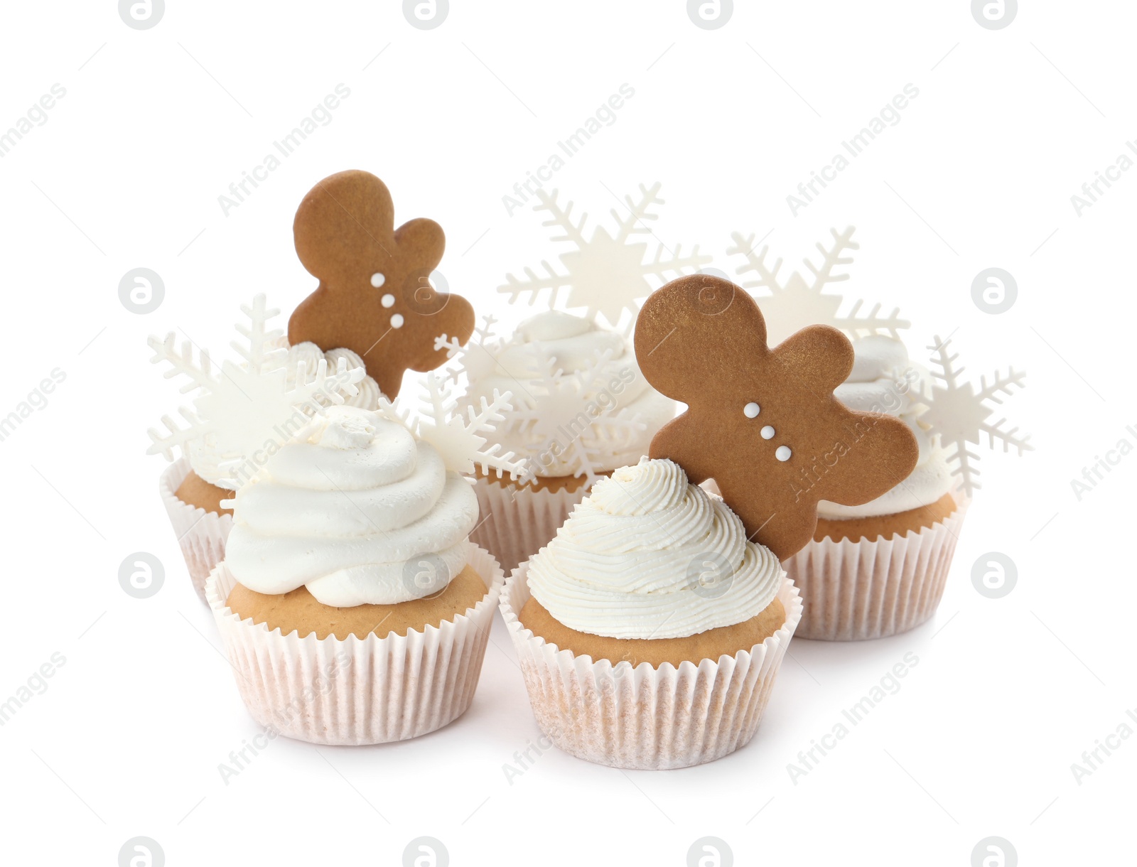Photo of Tasty Christmas cupcakes with snowflakes and gingerbread men on white background