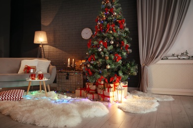 Photo of Stylish room interior with decorated Christmas tree