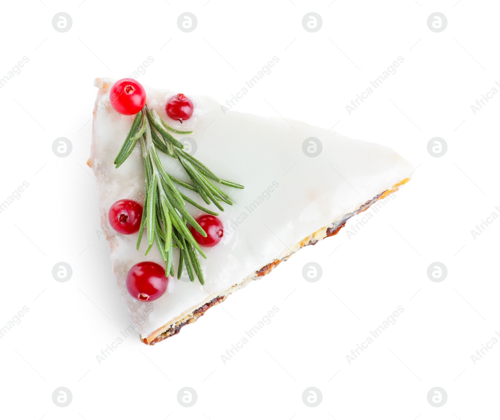 Photo of Slice of traditional Christmas cake decorated with rosemary and cranberries isolated on white, top view