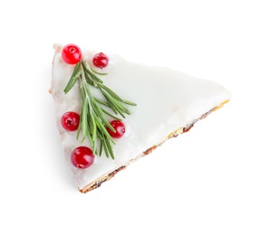 Photo of Slice of traditional Christmas cake decorated with rosemary and cranberries isolated on white, top view