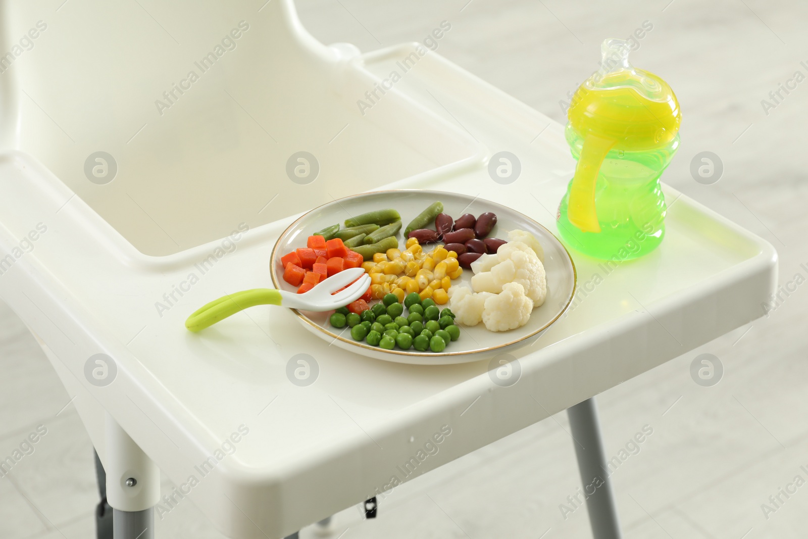 Photo of Baby high chair with healthy food and water