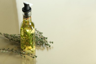 Cooking oil with spices and herbs in bottle on colorful table. Space for text