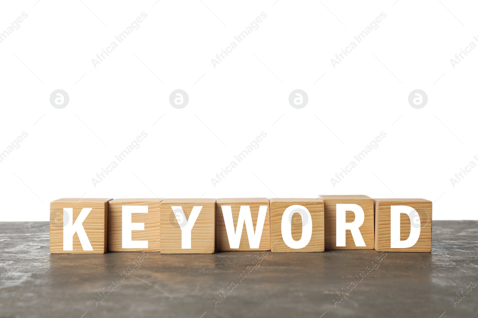 Photo of Wooden cubes with word KEYWORD on grey table