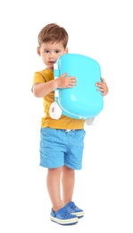 Cute little boy holding blue suitcase on white background