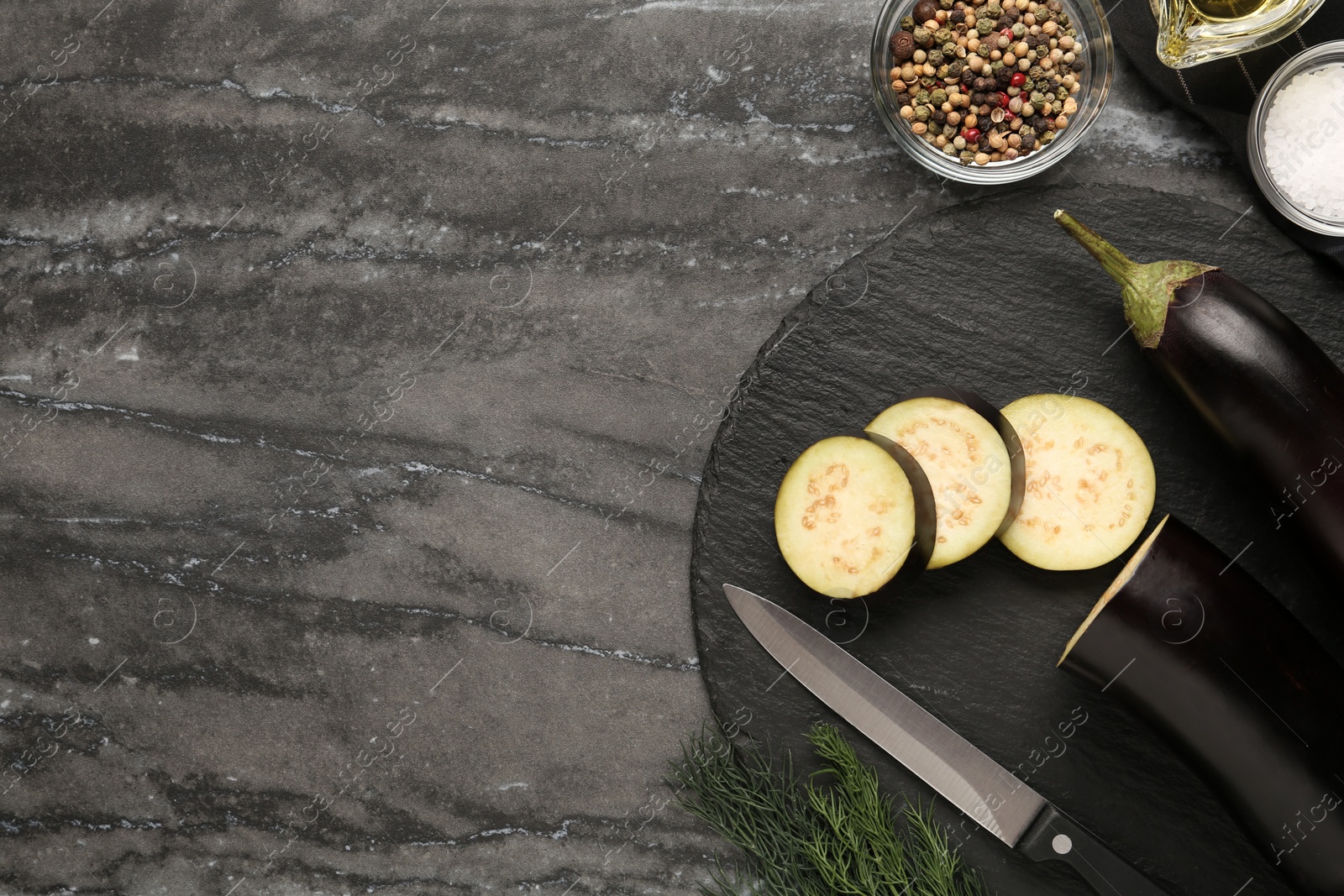 Photo of Fresh eggplants on grey table, flat lay. Space for text