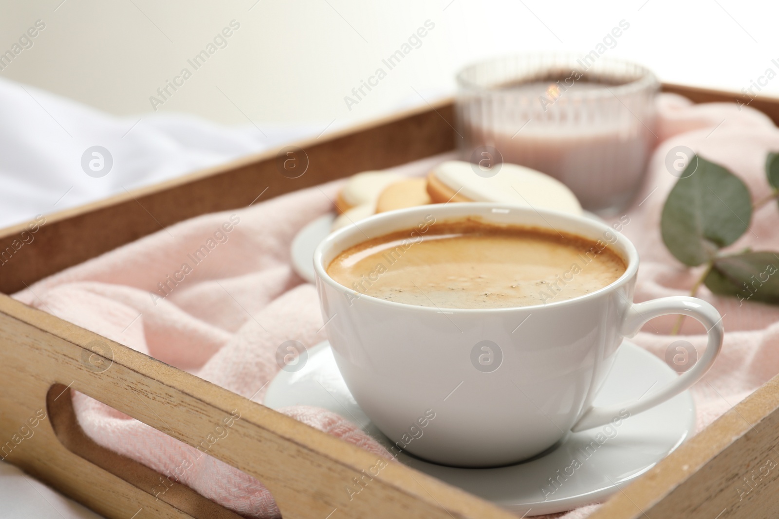 Photo of Aromatic coffee on wooden tray. Tasty breakfast