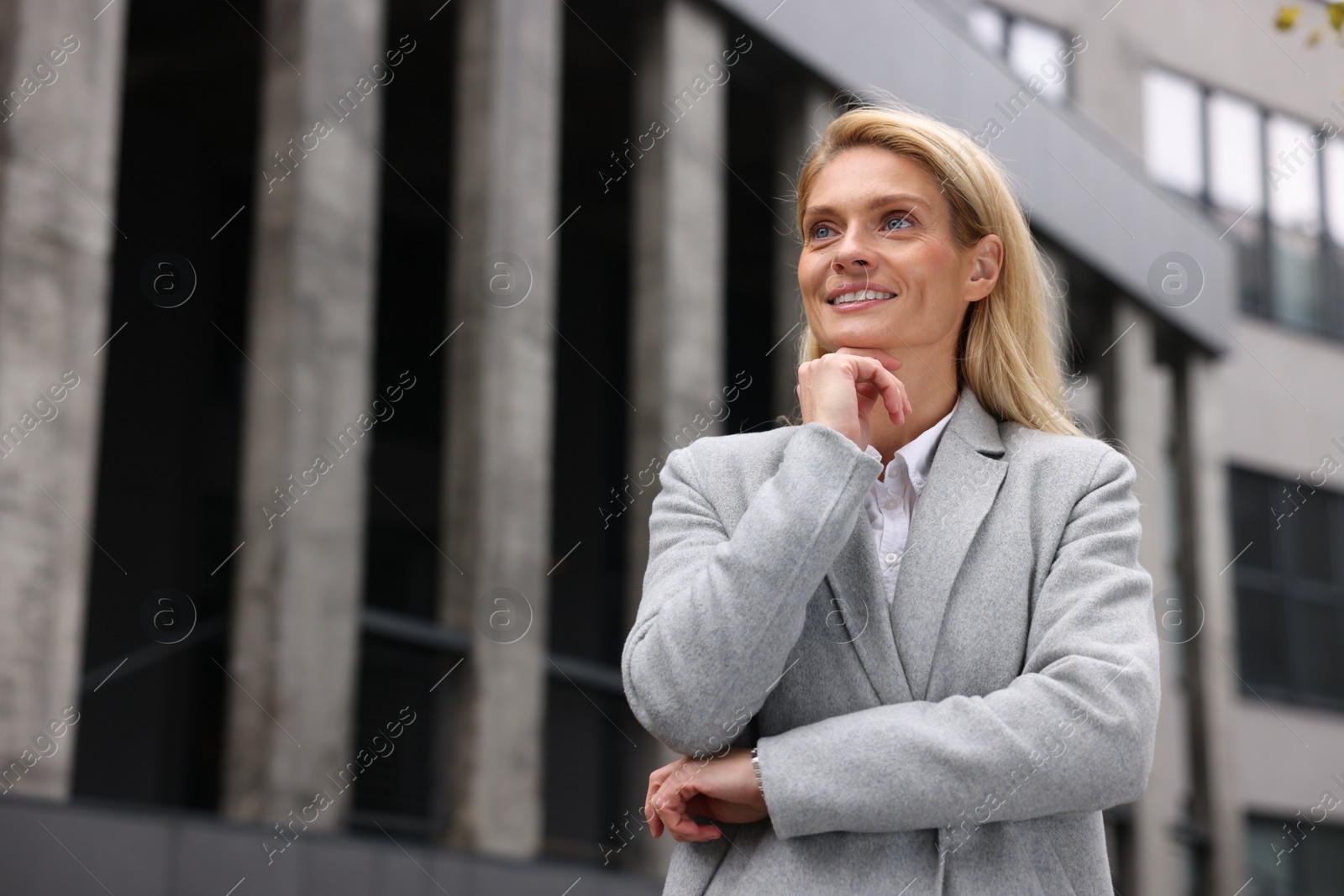 Photo of Portrait of happy woman outdoors, space for text. Lawyer, businesswoman, accountant or manager