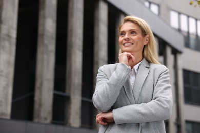 Portrait of happy woman outdoors, space for text. Lawyer, businesswoman, accountant or manager