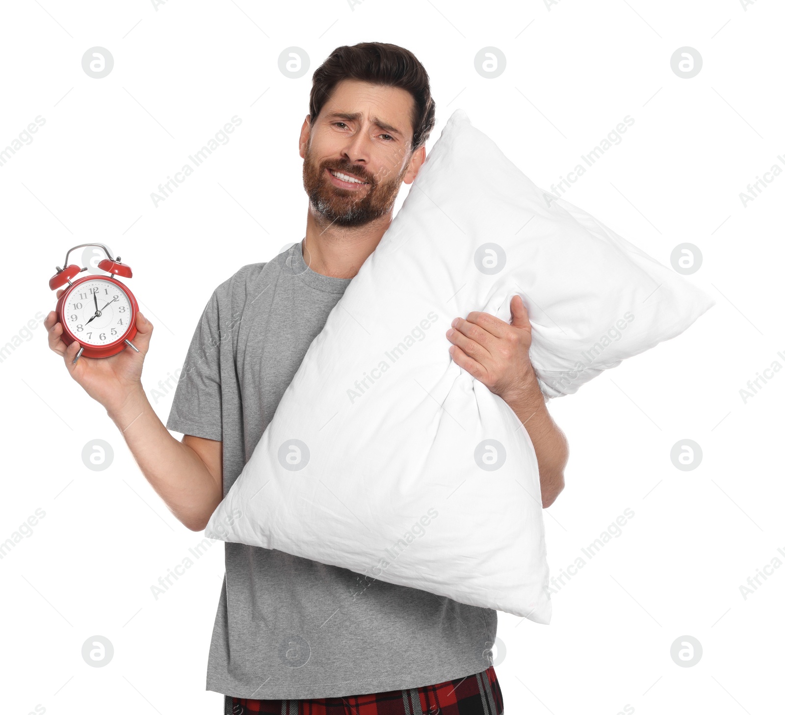 Photo of Sad overslept man with alarm clock and pillow on white background