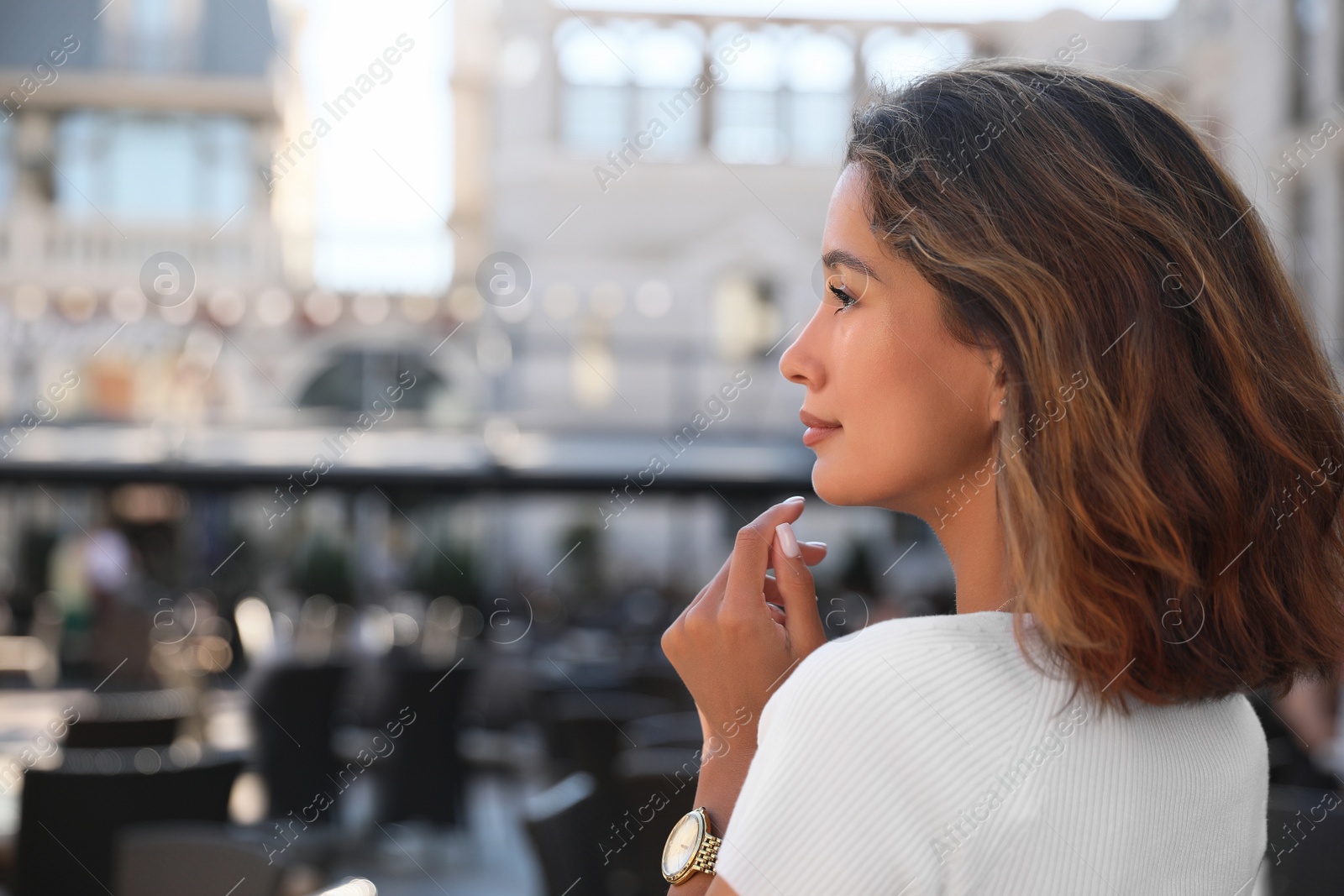 Photo of Portrait of happy young woman on city street. Space for text