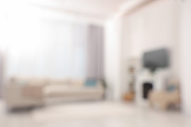 Photo of Blurred view of stylish living room interior with cozy sofa